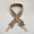 Detail of jacquard woven strap with red green geometric pattern and gold metal hooks - No.1 Green Brown + Gold Buckle