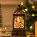 Vintage bronze Christmas lantern with Santa snow globe scene and golden light bokeh - Sitting Santa