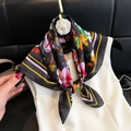 Elegant black silk scarf with vibrant floral print and yellow border on white dress - Square Scarf 59 / 65