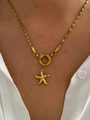 Golden starfish pendant necklace with a twist chain shown on a white shirt - Gold Starfish Necklace