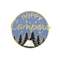 Macro shot of circular enamel camping pin with HAPPY Campers text and forest design - HAPPY Campers
