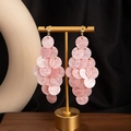 Detailed close-up of pink marble acrylic round fringe drop earrings on a display stand - H3533-2 Style