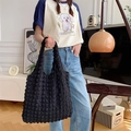 Detail shot of black bubble textured tote bag showing unique 3D pleated fabric texture - Black