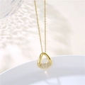 Detail of 18K gold Mobius necklace featuring irregular geometric pendant and zircon inlay - Gold