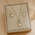 Golden drop necklace and earrings set with rhinestones and pearls on jewelry box - Cross Teardrop Necklace and Earrings Set (5962401)