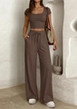 Detail of coffee brown ribbed knit fabric on high waist wide leg pants and crop top - S / Brown