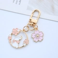 Detailed view of cherry blossom bunny wreath keychain with gold-plated lobster clasp - Bowtie Rabbit - Gate Clasp / Gold