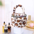 Detailed view of leopard print plush cylindrical makeup bag with rainbow zipper. - Beige