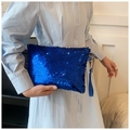 Detailed view of shimmering electric blue sequins and wristlet strap on a mini clutch bag - Blue