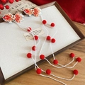 Detail of embroidered koi fish hair clip with long tassel and red plush pom poms - Red and White Koi Tassel Style