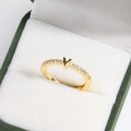 Detailed close-up of a 18k gold plated brass V-shaped ring with pavé diamonds in a jewelry box - Essential V Gold