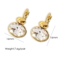 Detail of 16mm gold oval leverback earrings featuring large sparkling cubic zirconia - White