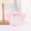 Cute pink plush cat ear headband accessory displayed on a wooden lamp in cozy room - Pink Cat Ears