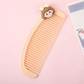 Cute light orange moon-shaped comb with a cartoon girl character on pink background - Little Girl