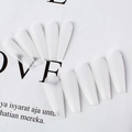 Detailed macro view of matte frosted coffin press-on nails in elegant soft white color - Foggy Clear