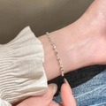 Close-up of minimalist silver beaded bracelet worn on wrist with white shirt - Silver Regular Round Bead Chain (MY33637)