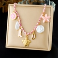 Pink woven charm bracelet with gold turtle, shell, starfish, and pearl pendants on a box - Turtle Shell Starfish Pink Boot Pendant Style (N3688)