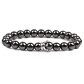 Close-up of black beaded stone bracelet featuring a silver crown charm on white background - Smooth Silver Small Crown