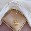 Detailed macro view of gold plated necklace with blue and white eye-shaped pendant - D116 Titanium Steel Chain Copper Pendant
