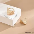 Detailed macro view of gold-textured irregular triangular earrings with fine mesh pattern - Gold Triangle