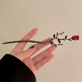 Detailed view of vintage gothic rose hair pin with dark metal branch and red rose bud - Dark Branch Red Bud / Gunmetal