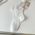 White Lolita ruffle socks with lace trim and vintage knit texture on a white table - One Size / Pure White Dots