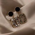 Detail of geometric earrings with grey crystals on elegant champagne silk background - Gold Base Black Circle Olive Green Zirconia Dangle (A50 Black Diamond)