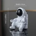 White resin astronaut figurine in sitting pose with black visor, size 4.5x5.2x4.1cm - Black Astronaut Ornament