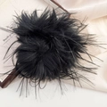 Detail of a large black faux fur scrunchie on silk background with soft lighting - Black