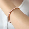 Bracciale tennis placcato oro con pietre di zircone rosa circolari su cordino elastico - Zircone Rosa Oro