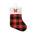 Detail of red and black buffalo plaid Christmas stocking with white faux fur and embroidered M - Letter M