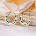 Polished silver hollow crescent hoop earrings displayed on white stone and champagne silk - 25mm / Round Pin / Steel
