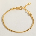 Detail of golden snake chain bracelet featuring heart pendant and lobster clasp closure - Lobster Clasp Heart Tail Gold