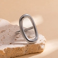 Detailed view of silver knot ring with oval cutout on a minimalist stone background - Steel Color 33