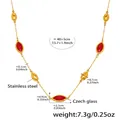 Detail view of gold stainless steel necklace featuring red glass stone and metallic beads - Gold Red