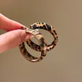 Retro leopard print resin hoop earrings for women shown held by hand for scale - Leopard C-Shape Acrylic Style (22#)