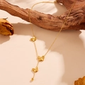 Golden butterfly tassel necklace with engraved butterfly pendants and steel beads - Gold Necklace
