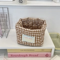 Detailed close-up of brown and white plaid quilted fabric storage basket on desk - 12x10cm / Brown