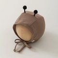 Close-up of brown knit baby bonnet with black plush antennae and secure chin straps - 35-45cm 0-12 Months / Coffee