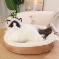 Realistic white and brown ragdoll cat plush toy sitting in a cozy round pet bed - White / 50cm