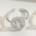 Macro view of S925 silver adjustable ring with relief medallion and paved crystals - White Zirconia (Silver)