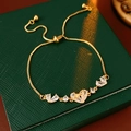 Detail of 18K gold-plated adjustable bracelet with sparkling heart-shaped zircon stones - Gold