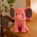 Soft pink plush elephant baby soothing toy with grey ears on a cozy wooden surface - Watermelon red