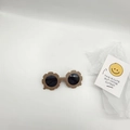 Detailed view of kids flower shaped sunglasses in matte brown with dark lenses - Gray