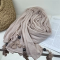 Detail of voile scarf with handmade tassels and beads on a beige pleated fabric - 77*180cm / Light Pink Beige