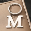 Polished silver metal keychain featuring a minimalist capital letter M pendant charm - M