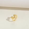 Minimalist hammered gold open ring featuring dual irregular discs on a sleek sand background - Irregular Heart Hammered Style