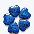 Blue spotted lapis lazuli crystal hearts arranged in a flower shape on a white base - Synthetic Lapis