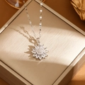 Elegant silver sunflower pendant necklace with sparkling zircons on a jewelry box - Silver Sunflower