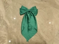 Elegant emerald green satin bow hair clip with long ribbons on marble background - Green